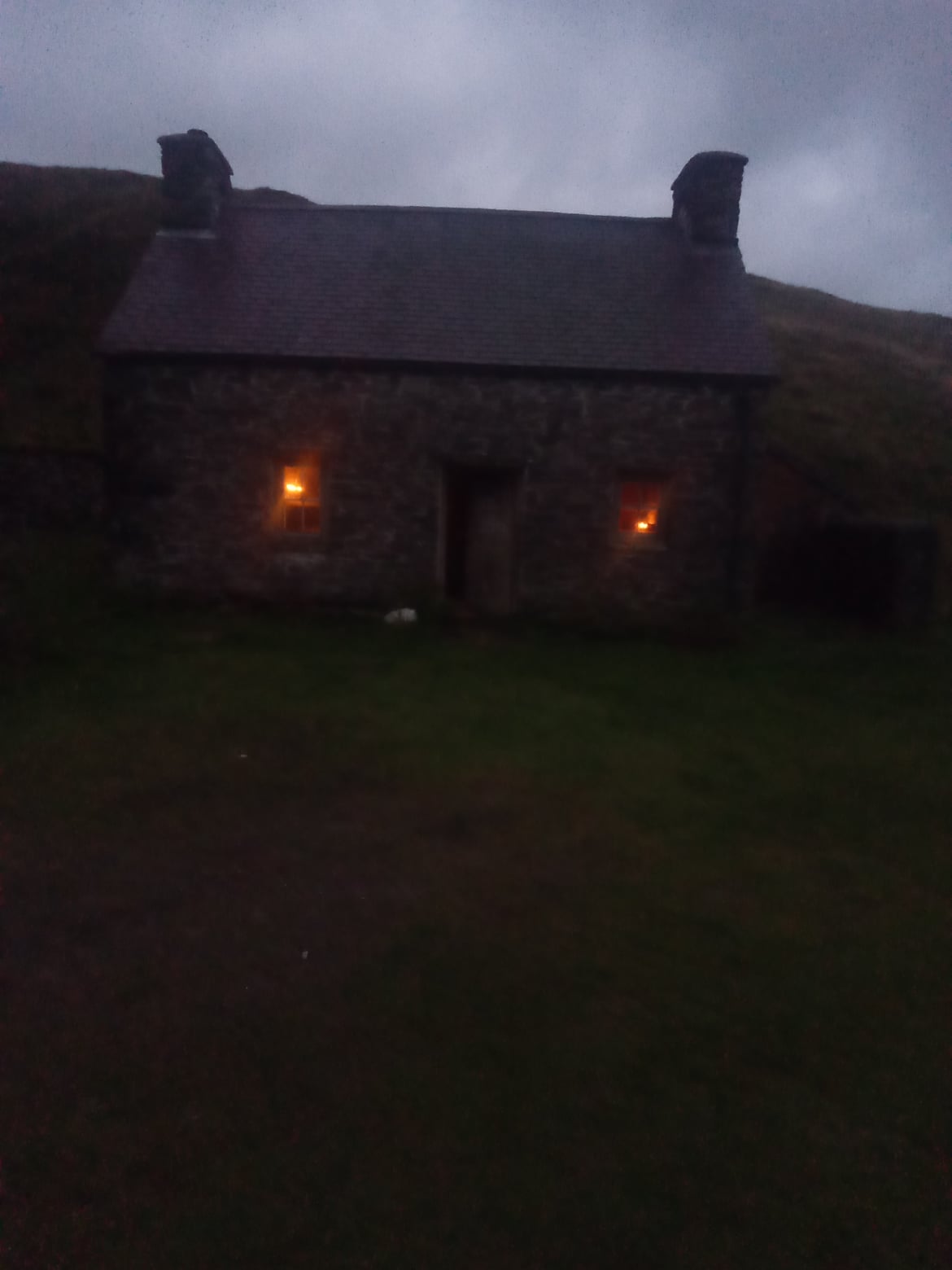 Claerddu Bothy at dusk in wild area.