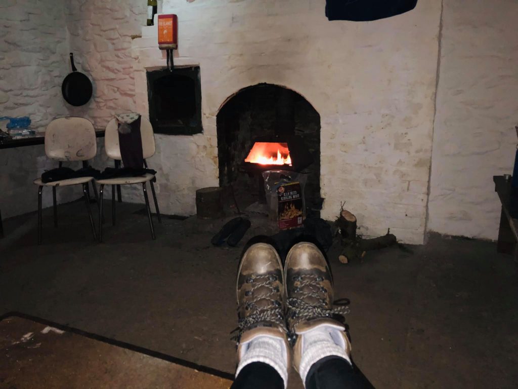 The bothy fire giving off heat and warming our feet and bodies.