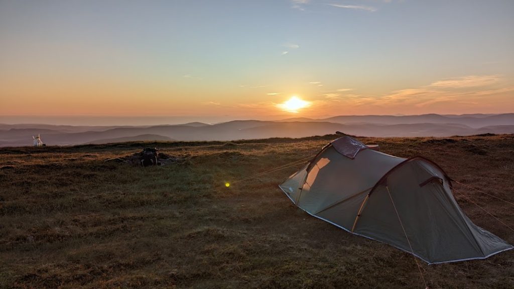 why go wild camping . View from mountain summit.